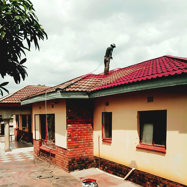 Roof-painting-a-house